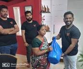 Lionbridge Mumbai team members exchanging garbage back for monsoon relief