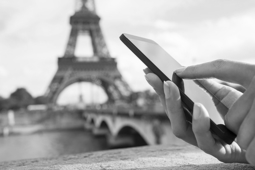 Tourist using phone before Eiffel Tower