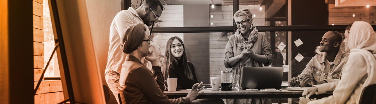 People sitting around a table collaborating on a creative project