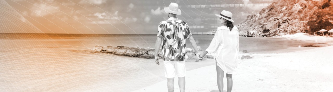 A couple holds hands at the beach.