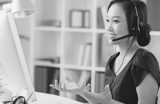 A woman talking on a headset