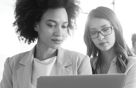 Two businesspeople looking at a tablet