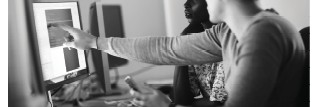 Two people collaborating on a computer over a project