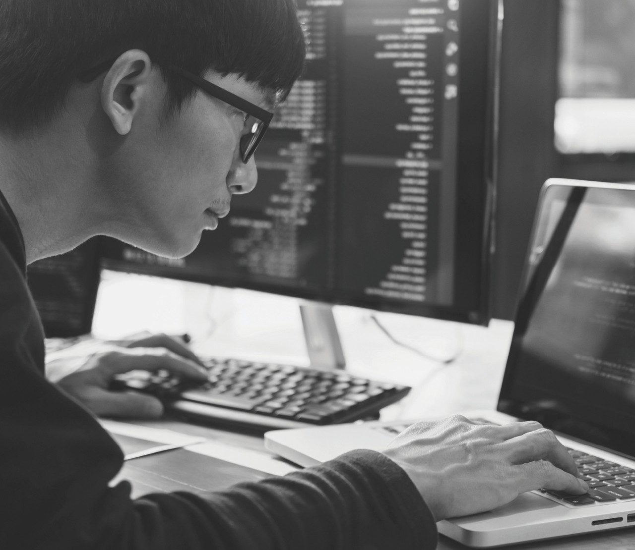 Person intently working on software code