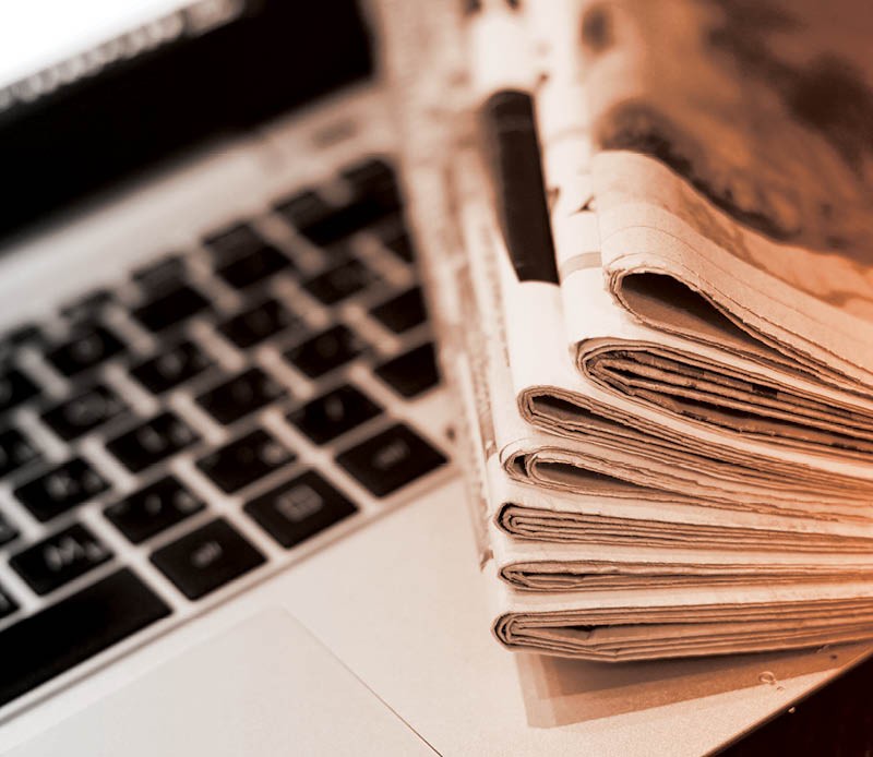 Newspapers on computer keyboard