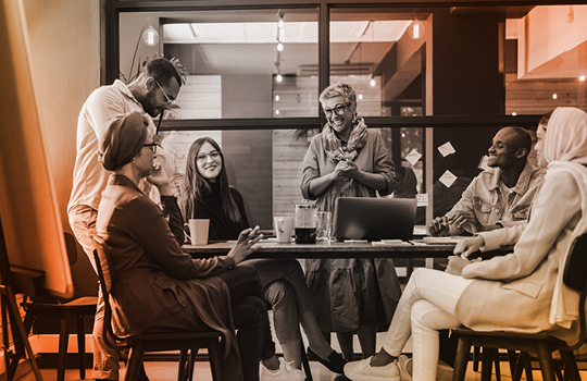 People sitting around a table collaborating on a creative project