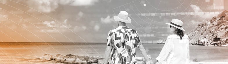 A couple holds hands at the beach.