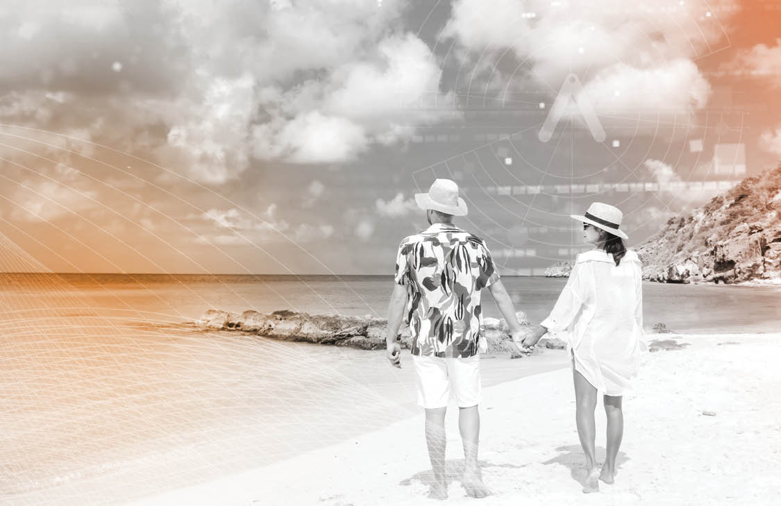 A couple holds hands at the beach.